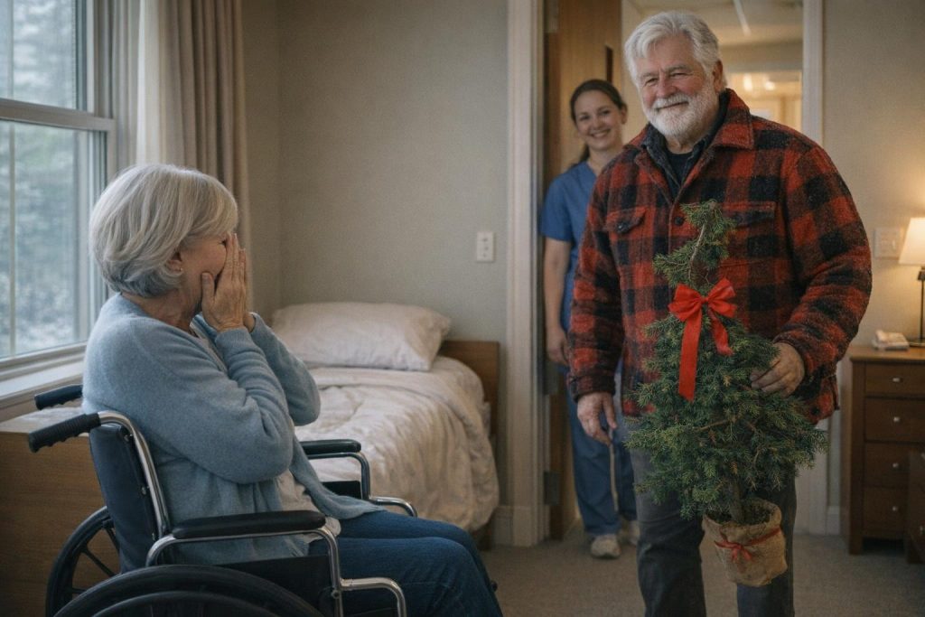 Older woman in a wheelchair surprised as a man carries a small crooked Christmas tree into her room